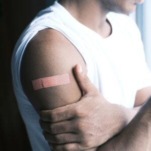 a person with a bandaid holding their arm